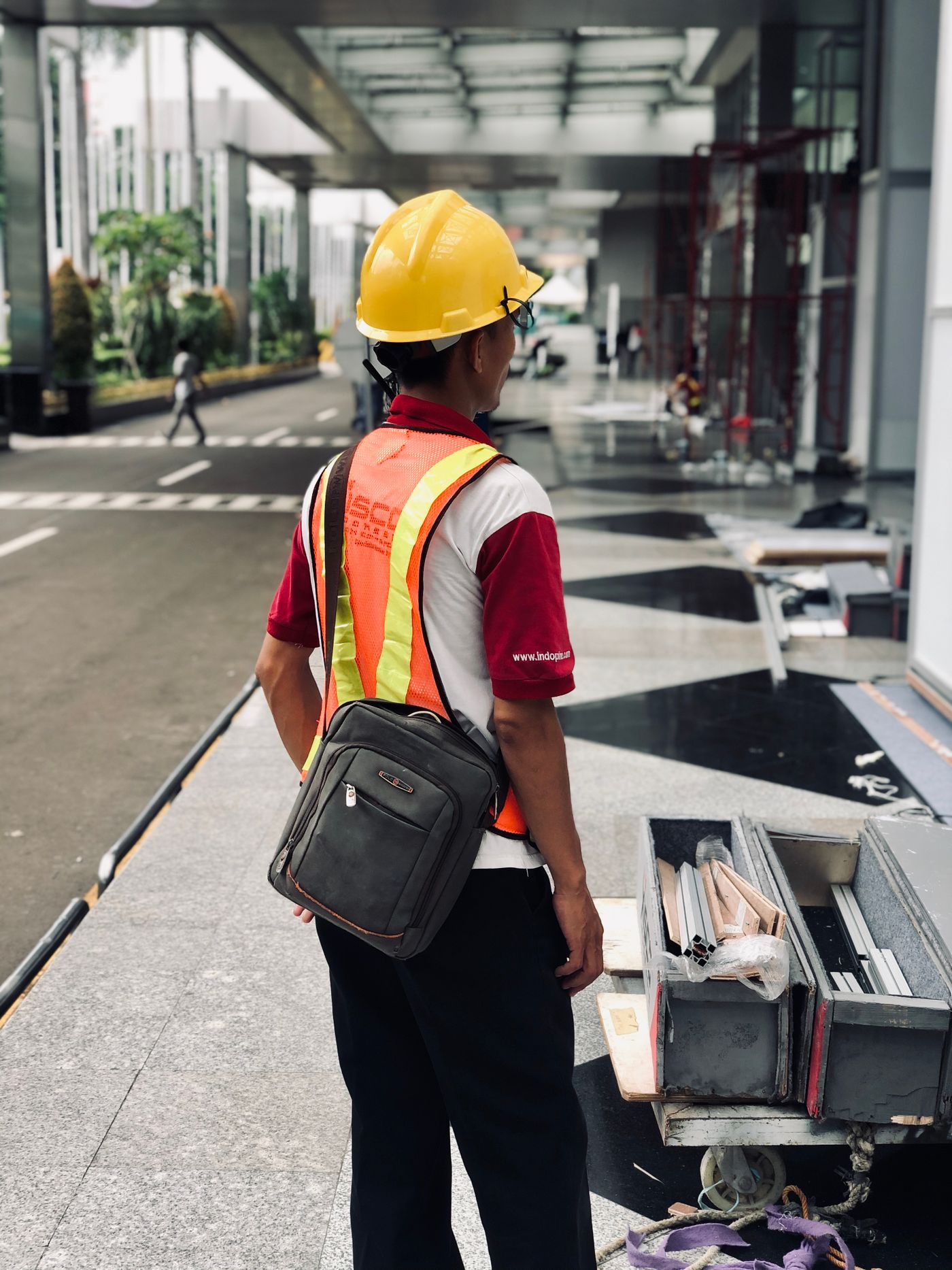 Worker wearing a helmet and high-visibility safety vest
